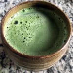 Matcha latte in cup green bubbles
